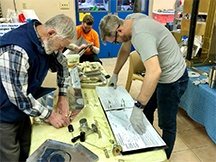 three men working on plans