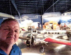 Chapter 54 member Tom Gibbons standing in front of a display at the Pulsar reunion in September 2024.