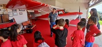 Al Kupferschmidt gives Farnsworth students an up-close view of his Citabria during a hangar tour on June 5, 2025