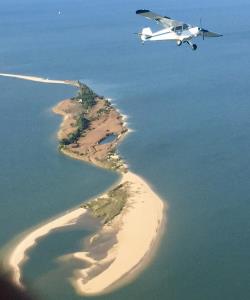 PA-12 climbing away from Shark Tooth Island, VA
