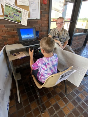 CAP cadet assists a futture pilot.