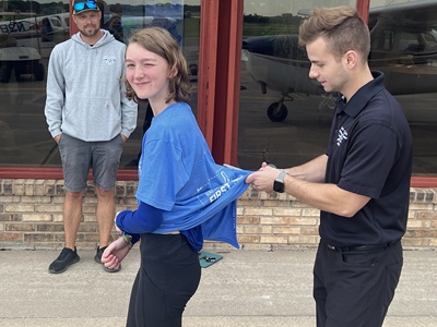 Anna Chase is congratulated after passing her checkride in January 2026, becoming the latest Chapter 54 pilot.