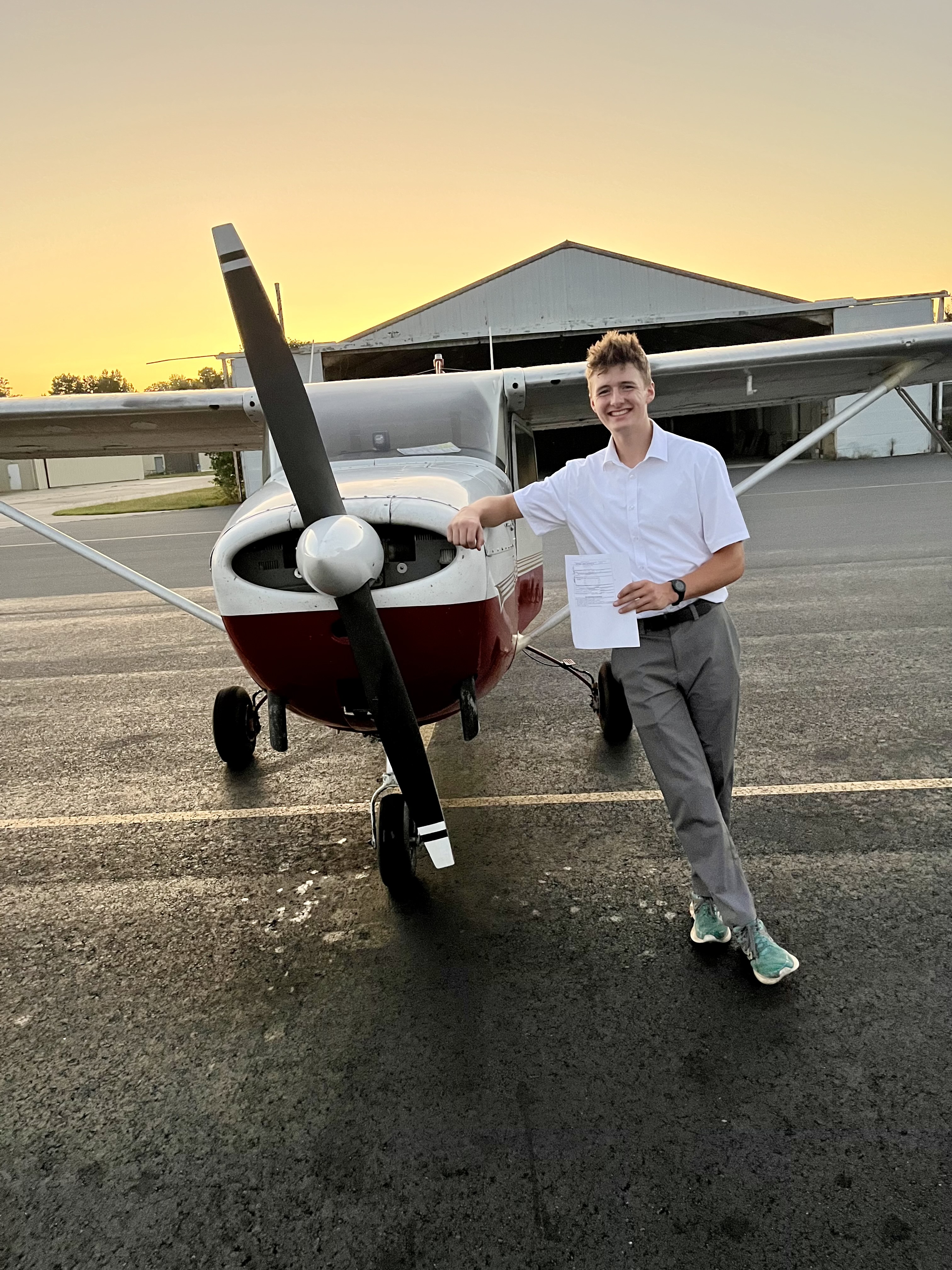 Mathew Lynes, EAA Chapter 54's first Ray Scholarship winner, poses with his plane after passing a checkride